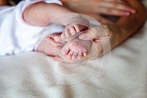 Baby feet and mother hands