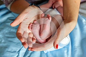 Baby feet and mother hands