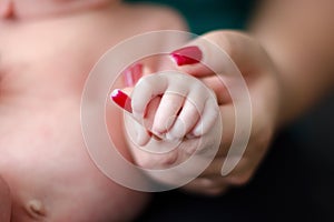 Baby feet in the mother hands. Family love concept. Newborn beauty.