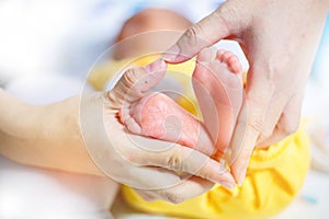 Baby feet in mother hands - hearth shape, Baby feet in mother hands. Mom and her Child. Happy Family concept. Beautiful conceptual