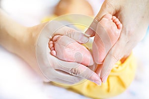 Baby feet in mother hands - hearth shape, Baby feet in mother hands. Mom and her Child. Happy Family concept. Beautiful conceptual