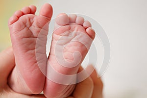 Baby feet in mother hands. Mom and her Child. Happy Family concept.