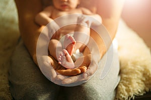 Baby feet in mother hands. Newborn Baby`s feet on hands