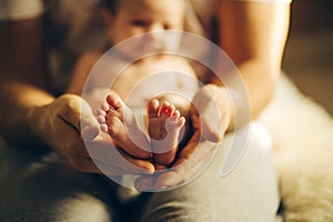 Baby feet in mother hands. Newborn Baby`s feet on hands