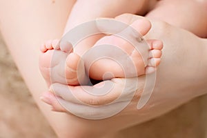 Baby feet in mother hands. Tiny Newborn Baby's feet