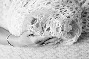 Baby feet in mother hands. Tiny newborn baby`s feet on female shaped hands closeup. Mom and her child.  Beautiful conceptual imag