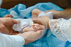 Baby feet in mother hands, tiny newborn baby`s feet on female shaped hands closeup, mom and her child, happy family concept, beau