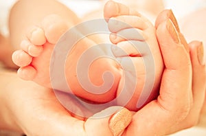 A Baby Feet in Mothers Hand