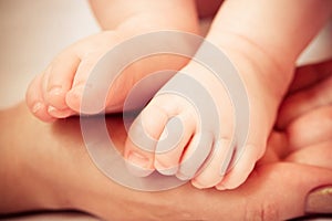 A Baby Feet in Mothers Hand