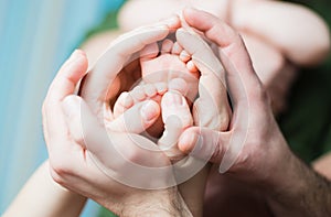 Baby feet on parents hands