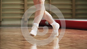 Baby feet in Pointe shoes. Practice ballet. Dancer. Slow motion. Close-up