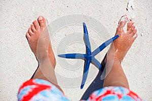 Baby feet with a starfish.