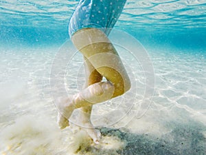 Baby feet walking underwater