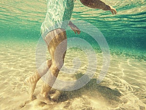 Baby feet walking underwater