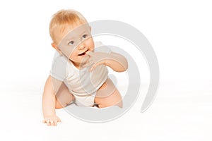 Baby with finger in his mouth wearing white body