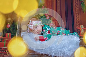 Baby first christmas. Beautiful little baby celebrates Christmas. New Year`s holidays
