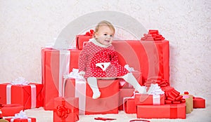 Baby first christmas once in lifetime event. Family holiday. Little baby girl play near pile of gift boxes. Gifts for