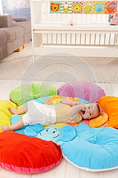 Baby on flowery playmat photo