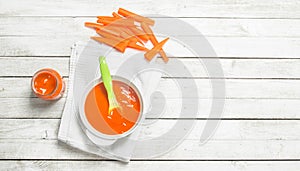 Baby food. Baby puree from fresh carrots with a spoon.