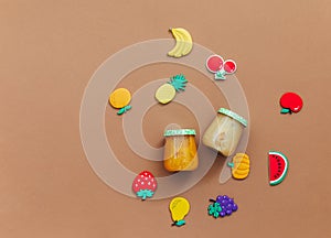 Baby food on brown light background, top view, copy space,