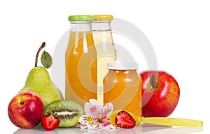 Baby food, puree and fruit juices in glass bottles isolated.