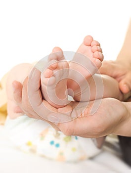 Baby foot in a mother hand