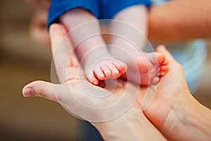 Baby foot in mother hands.