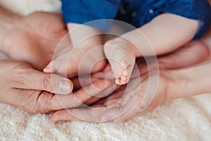 Baby foot in mother hands.