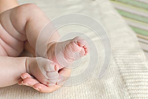 Baby foot in mother's hands