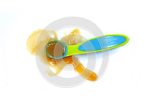 Baby fruit puree in a spoon isolated on white.