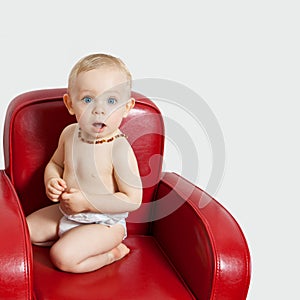 Baby girl on an armchair.bis