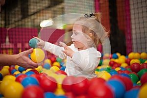 Baby girl in ball pool