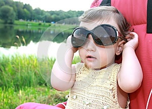 Baby girl in big sunglasses