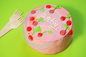 baby girl birthday cake on green background