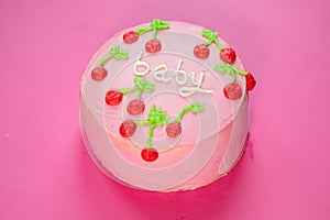 baby girl birthday cake on pink background