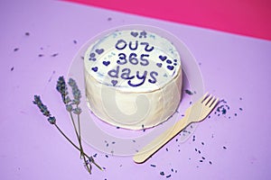 baby girl birthday cake on violet background