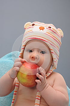 Baby girl bite organic apple