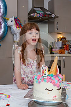 Baby Girl Blowing Candles Of A Birthday Cake