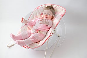 Baby girl on a bouncer photo