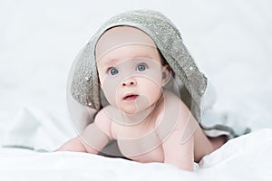 Baby girl or boy after shower with towel on head
