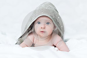 Baby girl or boy after shower with towel on head