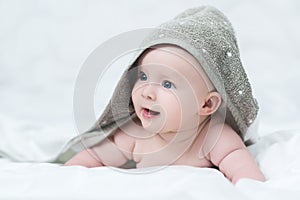 Baby girl or boy after shower with towel on head