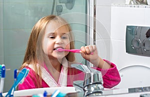 Baby Girl Brushing Her Teeth in the Morning at Bathroom