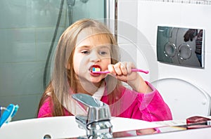 Baby Girl Brushing Her Teeth in the Morning at Bathroom