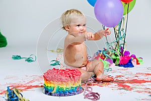 Baby girl celebrating her first bithday with gourmet cake.