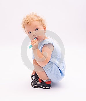 Baby girl cleans her milk teeth