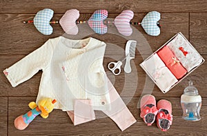 Baby Girl Clothes Accessories and Colorful Toys on a Tabletop Flat Lay Arrangement
