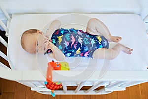 Baby girl in co-sleeper crib