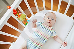 Baby girl in co-sleeper crib