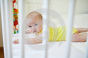Baby girl in co-sleeper crib